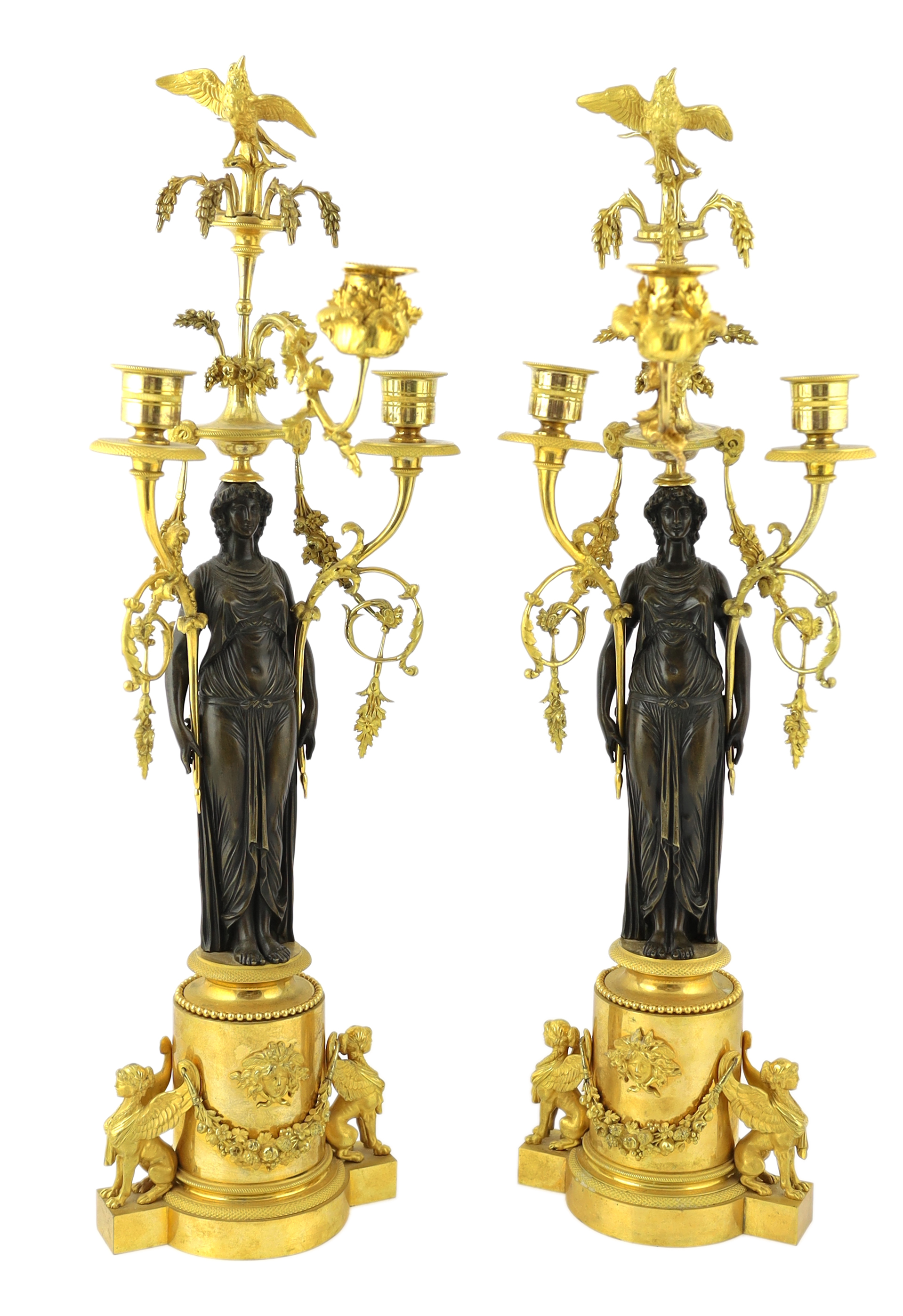 A pair of late 19th century French Empire style bronze and ormolu three light candelabra, 20cm wide, 63cm high, Please note this lot attracts an additional import tax of 5% on the hammer price